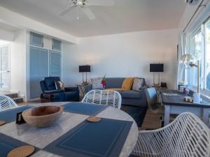 a living room with a couch and a table and chairs at Antigua Village Beach Resort in Saint Johnʼs