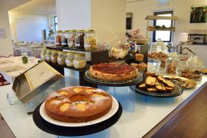 un mostrador con muchos tipos diferentes de pasteles y repostería en Hotel Borgo Brianteo, en Ponte San Pietro