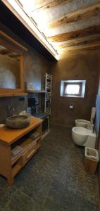 a large bathroom with a sink and a toilet at AL BAIT DA LUCIA Bormio in Bormio