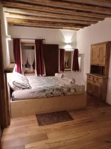 a bedroom with a large bed in a room at AL BAIT DA LUCIA Bormio in Bormio