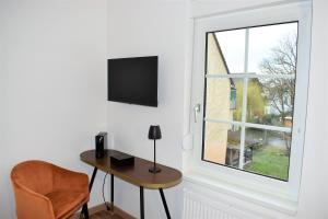 a room with a desk and a window and a chair at Black Forest Hotel Kappel-Grafenhausen in Kappel-Grafenhausen