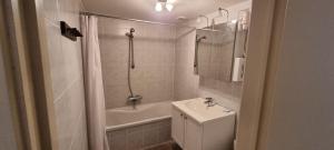 a bathroom with a sink and a shower and a toilet at Alliance Hotel Ieper Centrum in Ypres