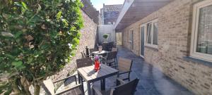 an empty patio with tables and chairs on a building at Alliance Hotel Ieper Centrum in Ypres