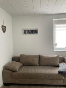 a couch in a living room with a window at Ferienwohnung Petra in Rust