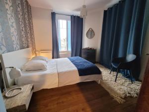 En eller flere senger på et rom på Appartements CDG JOIGNY