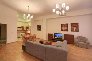 a living room with a couch and a dining room at Slunecni Lazne Apartments in Karlovy Vary