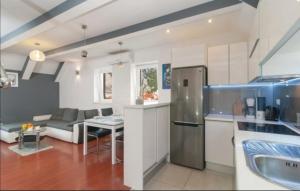 a kitchen and living room with a stainless steel refrigerator at Bika in Omiš