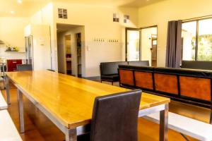 a dining room with a wooden table and chairs at Bellarine Lodge Sleeps 30 in Drysdale