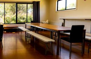 a conference room with a wooden table and chairs at Bellarine Lodge Sleeps 30 in Drysdale