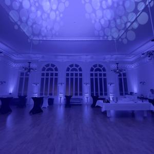 a purple room with tables and chairs in it at Salon Boyer in Épernay