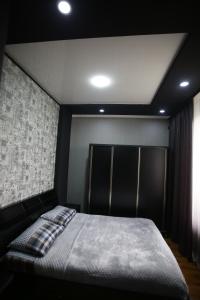 una camera con letto con testata nera di Guest House Nikola a Zugdidi