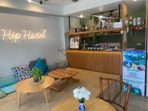 a coffee shop with two tables and a couch at Hip Hostel - SHA Plus in Patong Beach