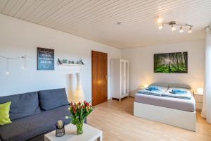 a living room with a couch and a bed at Wächtersberg in Wildberg