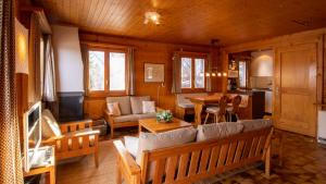 a living room with a couch and a table at Stachelbeere OG in Fiesch