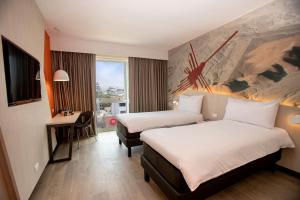 A bed or beds in a room at ibis Styles Lima Benavides Miraflores