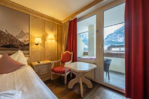 Ένα ή περισσότερα κρεβάτια σε δωμάτιο στο Hotel Spinne Grindelwald