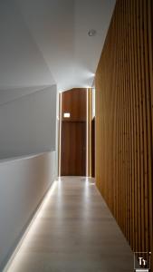 a hallway with a door and a wooden wall at Quinta das Donas in Anadia