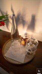 a plate with a bottle and containers on a table at Quinta das Donas in Anadia