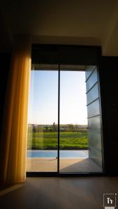 a large glass door with a view of a field at Quinta das Donas in Anadia