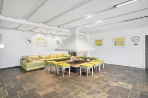 a living room with a couch and a table and chairs at Hotel Østersø in Aabenraa