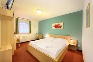 A bed or beds in a room at Penzion Krumlov - B&B - Massage studio