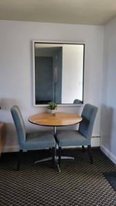 a table in an office with two chairs and a mirror at Lord Nelson Motel in Kingston