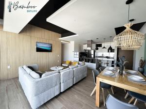 a living room with a couch and a table at Luxury Condo in Lobby33 near Andares By Bamboo in Guadalajara