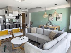 a living room with a couch and a table at Luxury Condo in Lobby33 near Andares By Bamboo in Guadalajara