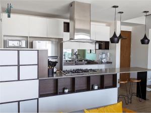 a kitchen with white cabinets and a counter top at Luxury Condo in Lobby33 near Andares By Bamboo in Guadalajara