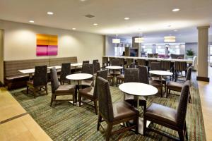 a restaurant with tables and chairs and a bar at Residence Inn by Marriott Chicago Wilmette/Skokie in Wilmette