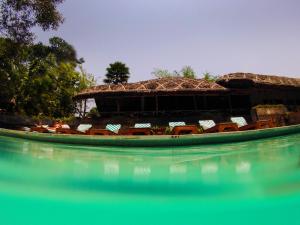 een boot in het water voor een gebouw bij Spice Village Thekkady - a CGH Earth Experience in Thekkady