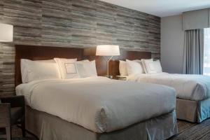 A bed or beds in a room at Fairfield by Marriott Waterbury Stowe