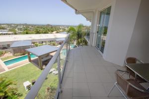 a balcony of a house with a table and chairs at Caloundra Central Apartment Hotel Official in Caloundra