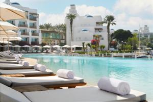 una fila de tumbonas junto a una piscina en Park Hyatt Dubai, en Dubái