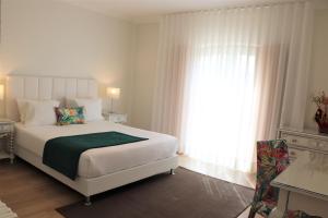 A bed or beds in a room at Casa Da Padeira - Turismo Rural