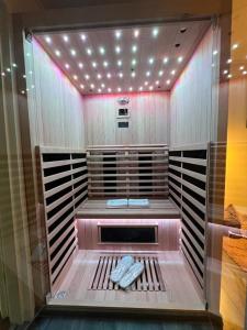 a walk in shower with lights in a room at Apartment Buga Bilje in Bilje