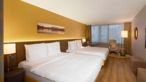 Cama ou camas em um quarto em Radisson Blu Hotel, Lucerne