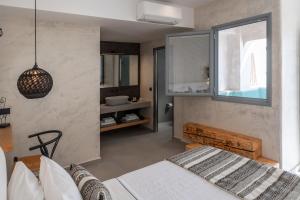 A bed or beds in a room at Almyra Oia Suites