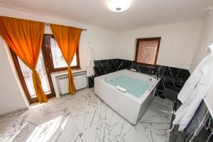 a bathroom with a bath tub in a room at Hedonist Spa Jacuzzi Sarajevo in Sarajevo