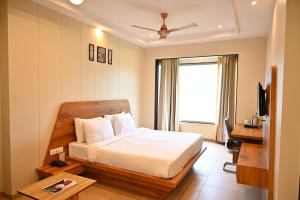 a hotel room with a bed and a television at DESI THATH RESORT in Alwar