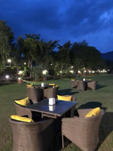 a table and chairs in a field at night at DESI THATH RESORT in Alwar