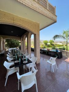 a row of tables and chairs on a patio at Namanbagh in Alwar