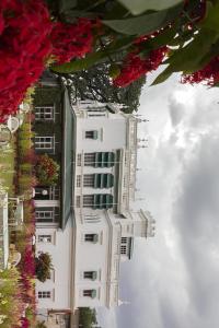 un edificio bianco con dei fiori sul lato di The Green Hotel a Mysore