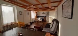 a living room with a table and chairs and a kitchen at Ker Karantez in Rennes