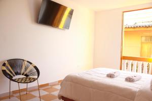 A bed or beds in a room at Hostal Casa Torres Centro Historico - Adults Only