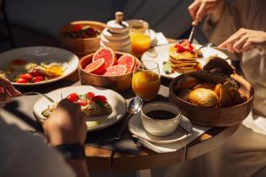 a table full of breakfast foods and drinks at Domes Noruz Mykonos in Mýkonos City