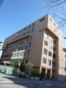 an apartment building on the corner of a street at Hotel Ceresio in Lugano