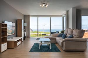 a living room with a couch and a table at SilverSide Holidays in Caldas da Rainha