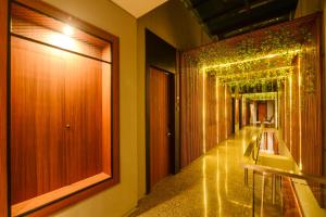 a corridor of a building with lights on the walls at Nata Azana Hotel Solo in Solo