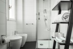 e bagno con doccia, servizi igienici e lavandino. di Brera Apartments in San Marco a Milano